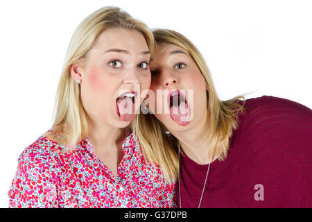 Two girls sticking tongue out Stock Photo