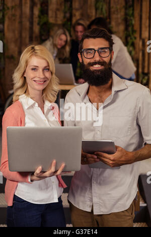 Team of hipsters using multimedia tools Stock Photo