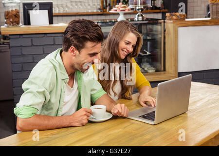 Smiling couple using a laptop Stock Photo