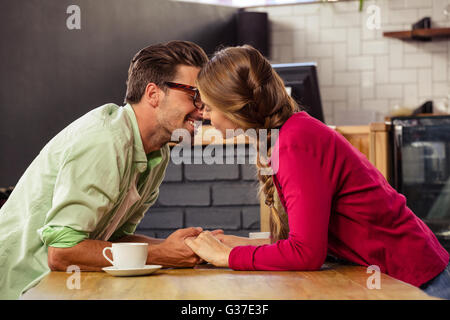 Young couple kissing each other in cafeteria Stock Photo