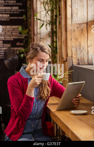 Beautiful young woman using digital tablet on sofa Stock Photo - Alamy