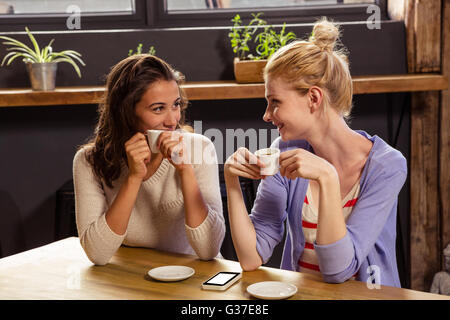 Smiling friends drinking coffee Stock Photo