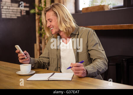 Handsome man using his phone Stock Photo