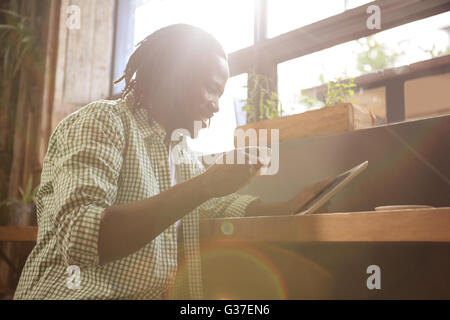 Man drinking coffee and using tablet Stock Photo