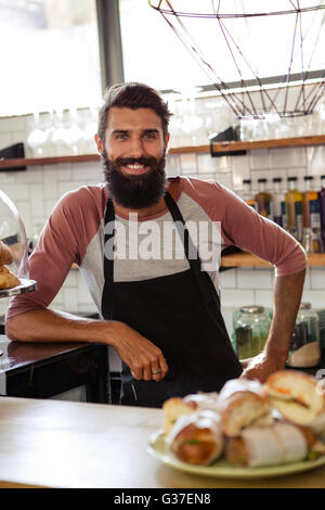 Waiter leaning against counter Stock Photo