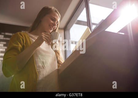 Smiling woman drinking coffee Stock Photo