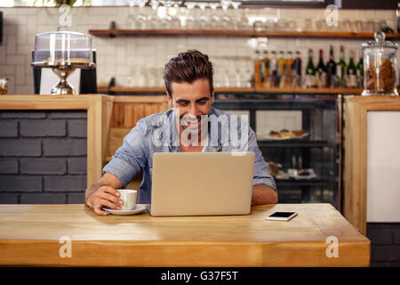 Happy hipster man using tablet and drinking coffee Stock Photo