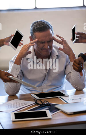 Overwhelmed businessman by his work Stock Photo