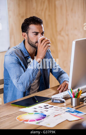 Businessman drinking a coffee and working Stock Photo