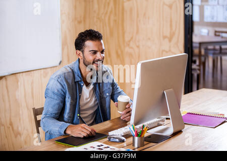 Businessman smiling and taking notes Stock Photo