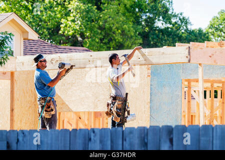 Two Hispanic men working on new construction in Oklahoma City, Oklahoma, USA. Stock Photo