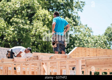 Two Hispanic men working on framing a new house in Oklahoma City, Oklahoma, USA. Stock Photo