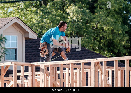 A Hispanic man working on framing a new house in Oklahoma City, Oklahoma, USA. Stock Photo