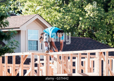 A Hispanic man working on and framing new construction in Oklahoma City, Oklahoma, USA. Stock Photo