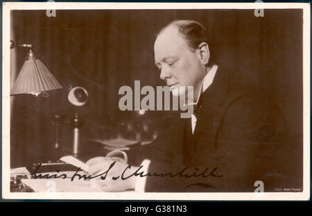 WINSTON CHURCHILL (1874-1965) British statesman and author  Reading correspondence at his  desk in 1933 Stock Photo