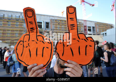 Berlin, Germany. 8th June, 2016. Demosntrators present two cardboard cut-outs of 'the finger' in their hands has they take part in a demonstration in front of the city palace underconstruction in Berlin, Germany, 8 June 2016. Around 300 people took part in a rally in favour of more affordable houseing in Berlin. Photo: Paul Zinken/dpa/Alamy Live News Stock Photo