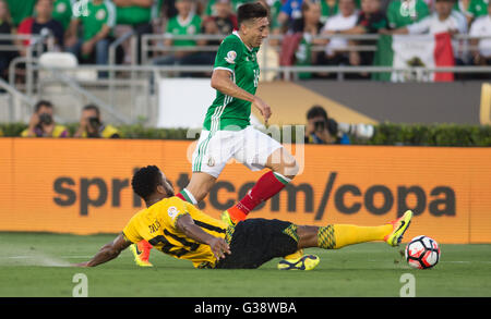 Pasadena, USA. 9th June, 2016. Mexico's Hector Herrera (top) vies with Jamaica's Jermaine Taylor during the Copa America Centenario tournament Group C football match in Pasadena, California, the United States, on June 9, 2016. Credit:  Yang Lei/Xinhua/Alamy Live News Stock Photo