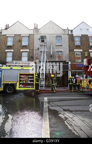 Harringay, North London 10 June 2016 Over 40 firefights, 8 fire engines attend a second floor flat over a cafebar in Green Lanes at the junction of St Anns Road, Harringay, North London. Credit:  Dinendra Haria/Alamy Live News Stock Photo