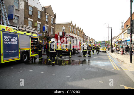 Harringay, North London 10 June 2016 Over 40 firefights, 8 fire engines attend a second floor flat over a cafebar in Green Lanes at the junction of St Anns Road, Harringay, North London. Credit:  Dinendra Haria/Alamy Live News Stock Photo