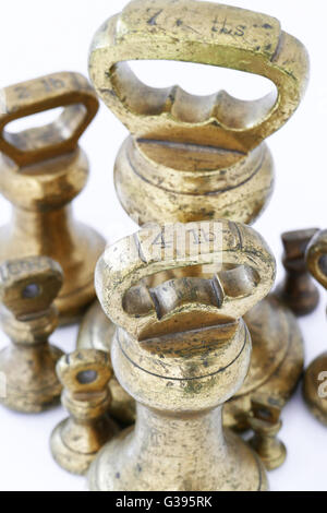 Old fashioned Imperial brass weights which were used on traditional scales,ranging from 4Lbs down to 1oz, pre metric. Stock Photo