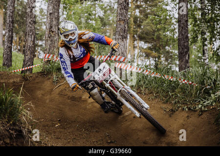 riders on bike rides in forest on a sharp turn during Cup 'Ryder' downhill Stock Photo