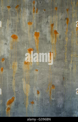 old green brown surface and concrete wall with rusted spots Stock Photo