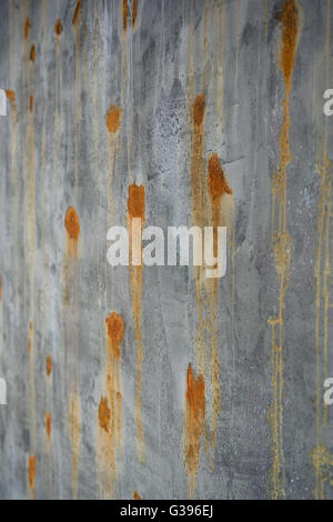 old green brown surface and concrete wall with rusted spots Stock Photo