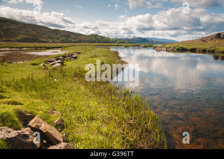 A low level photograph of the River Kishorn as it flows out into Loch Kishorn in the Scottish Highlands Stock Photo