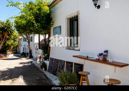 A Street In The Fishing Village Of Kouloura, Corfu Island, Greece Stock Photo