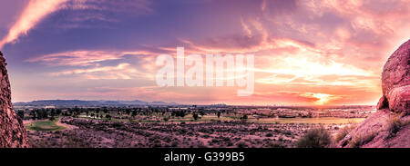 Panorama of sunset over late evening red sky over Phoenix,Arizona.  Papago Park buttes in foreground. Stock Photo