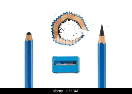 Sharp and unsharp blue pencils isolated on white background. Dirty blue sharpener and pencil shavings with dust in the center. Stock Photo
