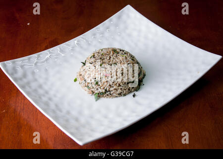 Nasi kerabu or herbed rice without condiments Stock Photo