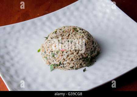 Nasi kerabu or herbed rice without condiments Stock Photo