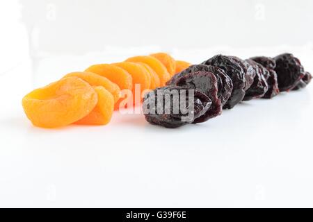 Dried apricots and plums fruits. Isolated on white background Stock Photo