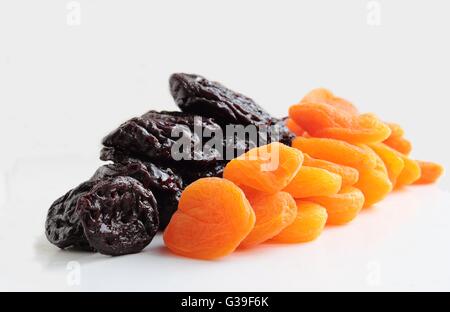 Dried apricots and plums isolated on white background Stock Photo