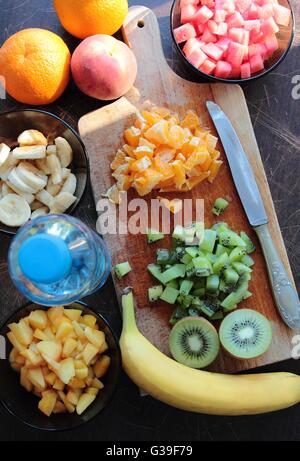 Fresh and sweet fruits cutting on wooden desk Stock Photo