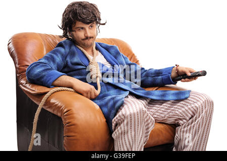 Bored young man watching TV and changing channels with a rope around his neck isolated on white background Stock Photo
