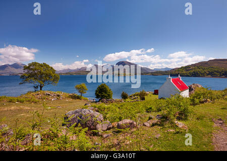 Cottage on coast above Loch Shieldaig. Applecross Peninsula, Ross and Cromarty, Scotland. Stock Photo