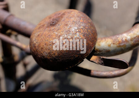 old rusty metal bicycle bell on handlebars Stock Photo