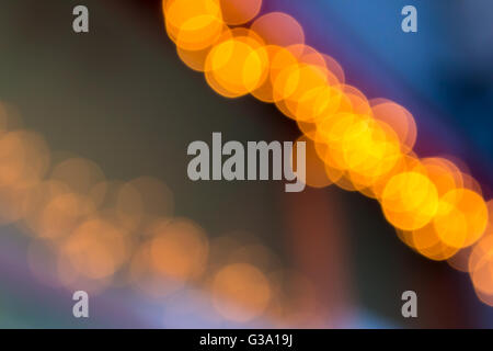 abstract background of blurred warm  lights with cool blue and purple background with bokeh effect Stock Photo
