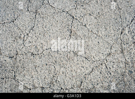 thin fissures and cracks in the gray concrete texture Stock Photo