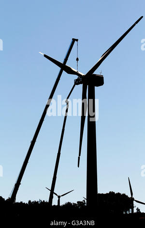 Wind turbine being repaired, assisted by crane and elevator Stock Photo