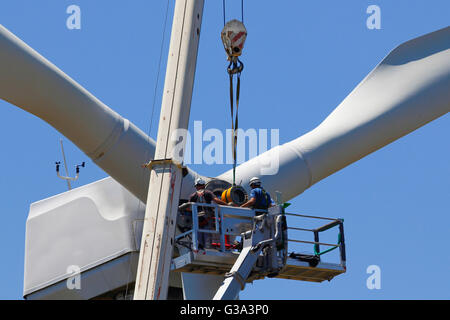 Wind turbine being repaired, assisted by crane and elevator Stock Photo