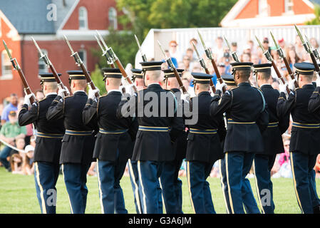 ARLINGTON, Virginia, USA - The US Army Drill Team performs as part of the US Army's Twilight Tattoo, which is held on Tuesday evenings in the summer at Joint Base Myer-Henderson Hall in Arlington, Virginia. The event features various Army regiments and personnel, with live music, marching bands, and historical reenactments. Stock Photo