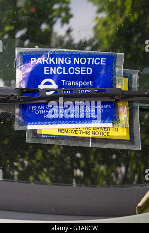 parking notice, issued by transport for london, under a wiper on a car windscreen in chiswick, london, england Stock Photo