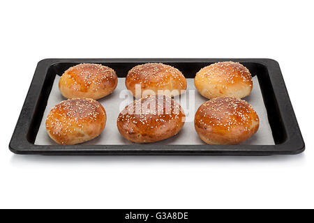Homemade bun for burger in black tray isolated on white