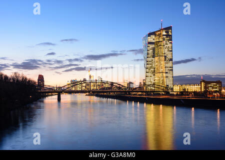 European Central Bank (ECB) with bridge Deutschherrnbrücke over the river Main, in the background the financial district, German Stock Photo