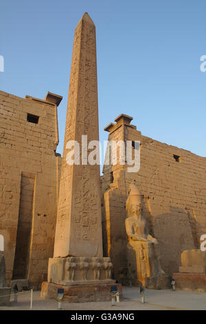 Luxor Temple, obelisk, statue of Ramses II and first Pylon. Luxor, Egypt Stock Photo