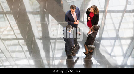 Corporate business people talking in modern office lobby Stock Photo