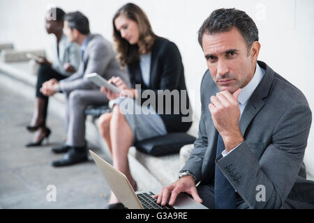 Portrait serious corporate businessman using laptop Stock Photo